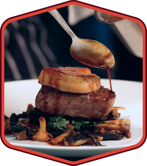 Chef finishing plated steak