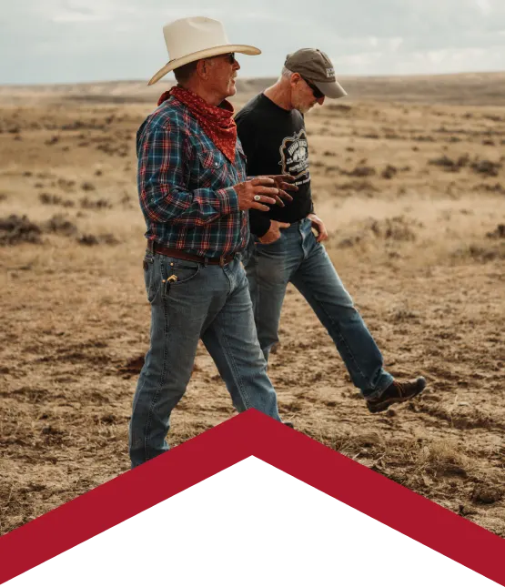 two people walking on working ranch