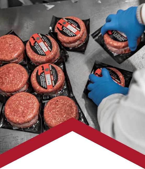 burger patties being portioned in production line